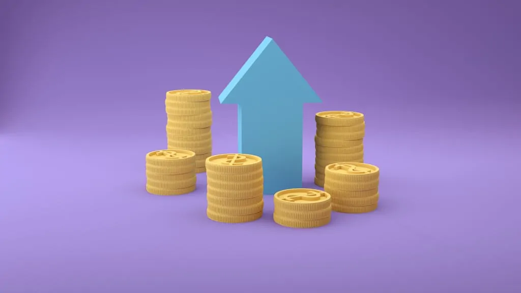 Stacks of coins with an upward arrow symbolizing financial growth and success.